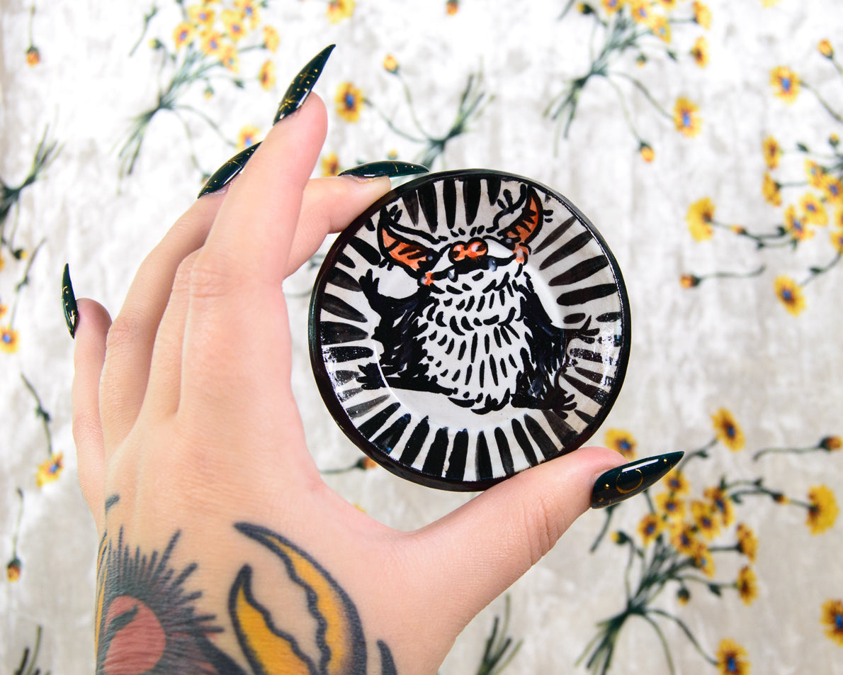 Decorative ring dish with a painted cartoon bat design