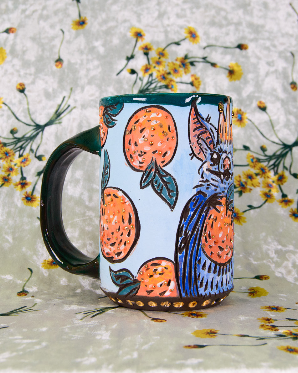 Ceramic mug with stylized orange fruit designs