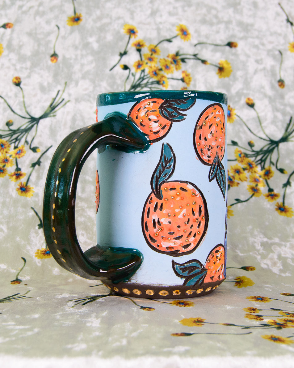 Mug with orange design on a floral background
