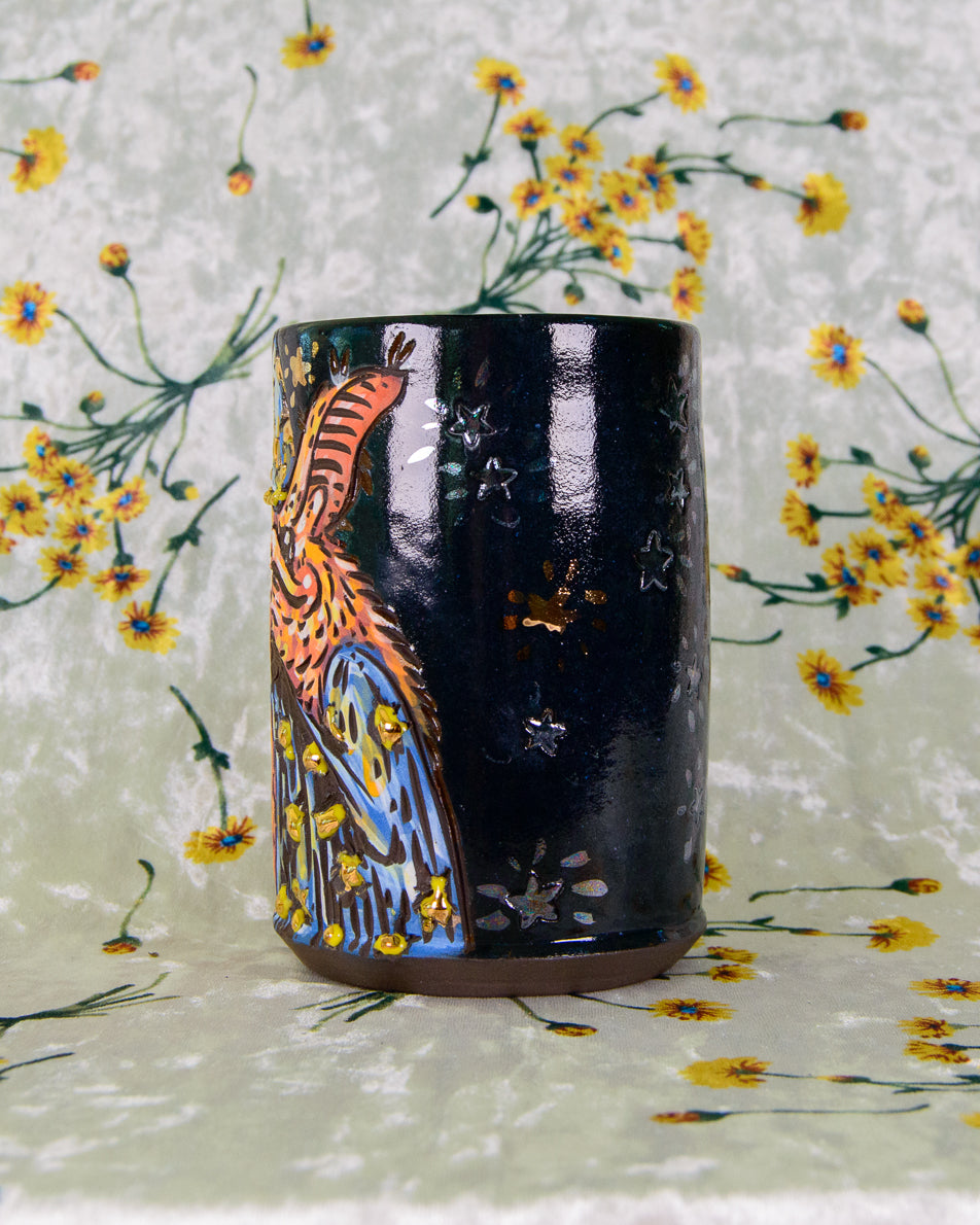Black ceramic cup with gold and rainbow pearl stars
