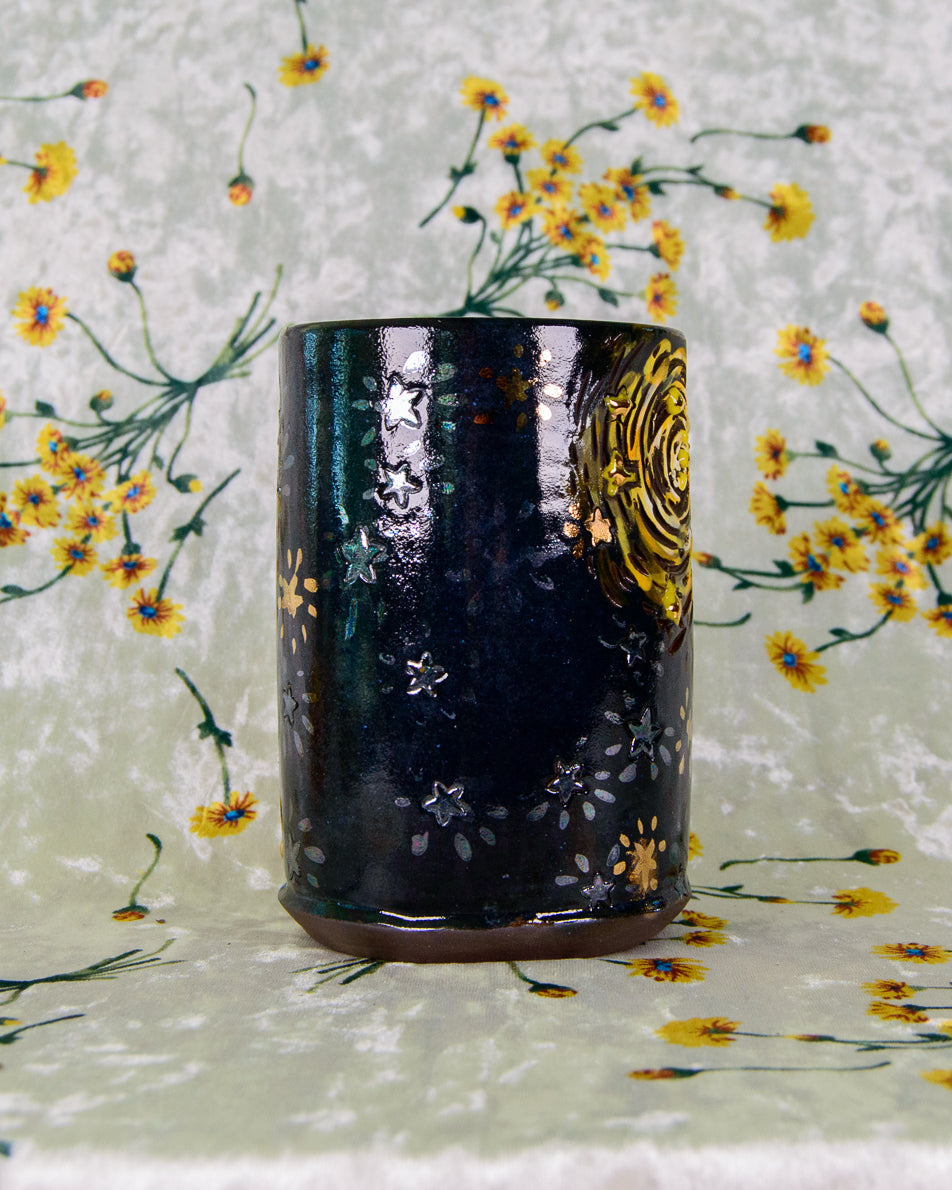 Black ceramic cup with gold and rainbow shiny star designs