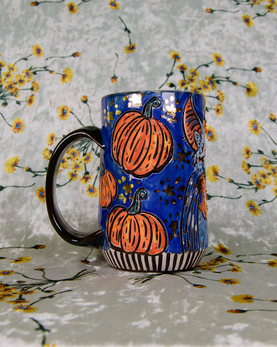 Blue glazed ceramic mug with cute halloween pumpkin designs
