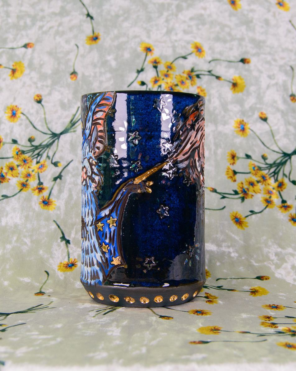 Blue and black ceramic mug with gold and rainbow luster details