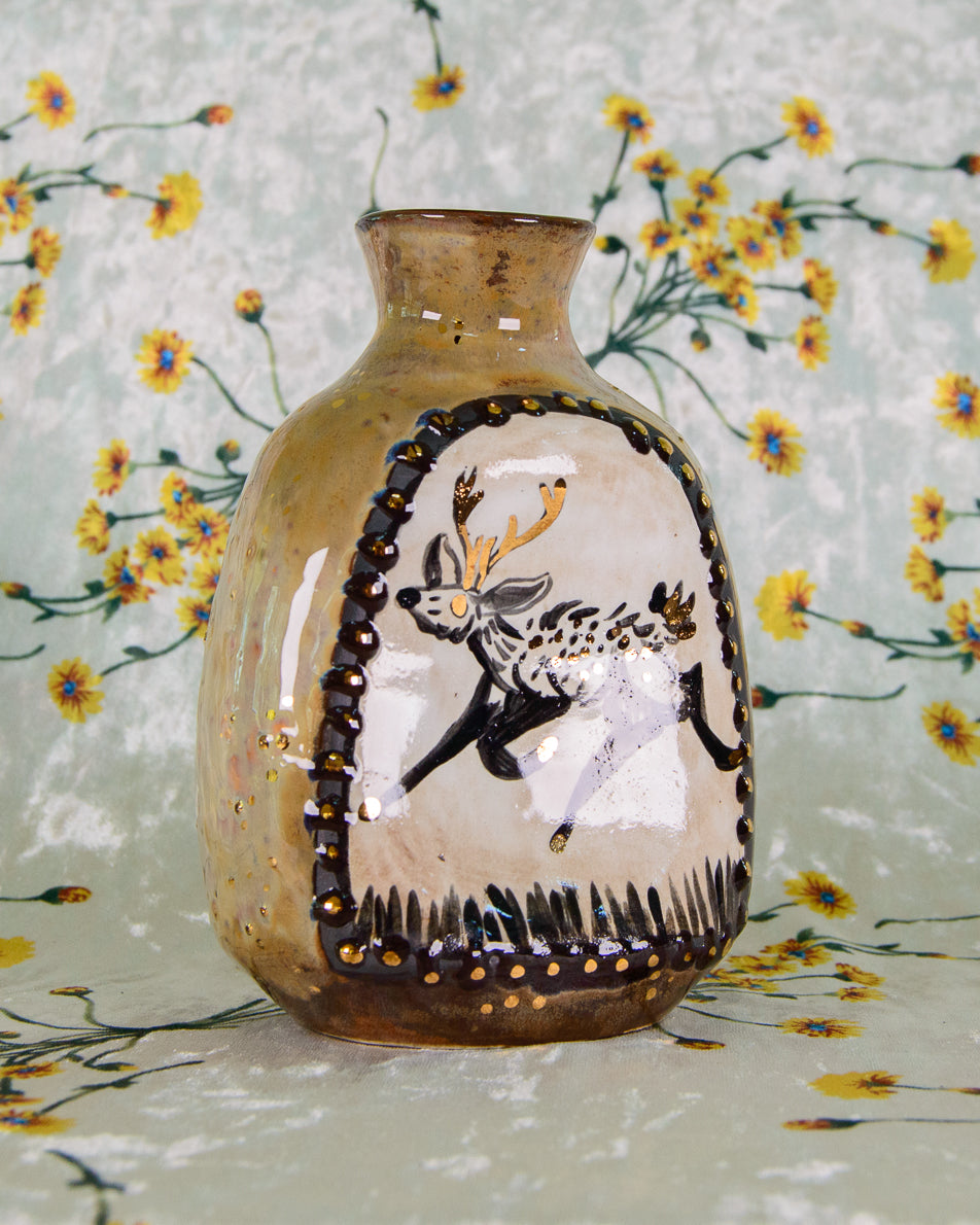 Decorative vase with a deer design on a floral background
