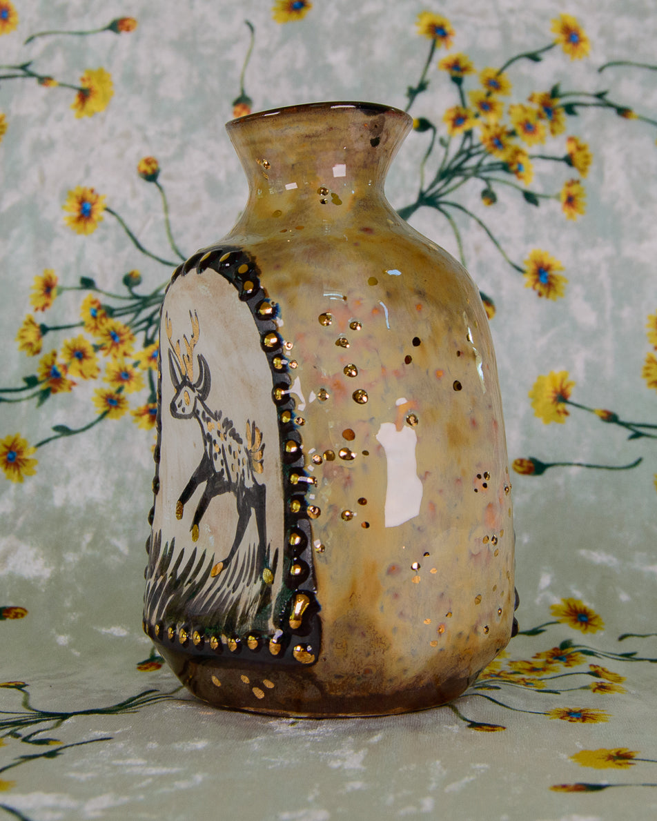 Decorative vase with a deer design on a floral background