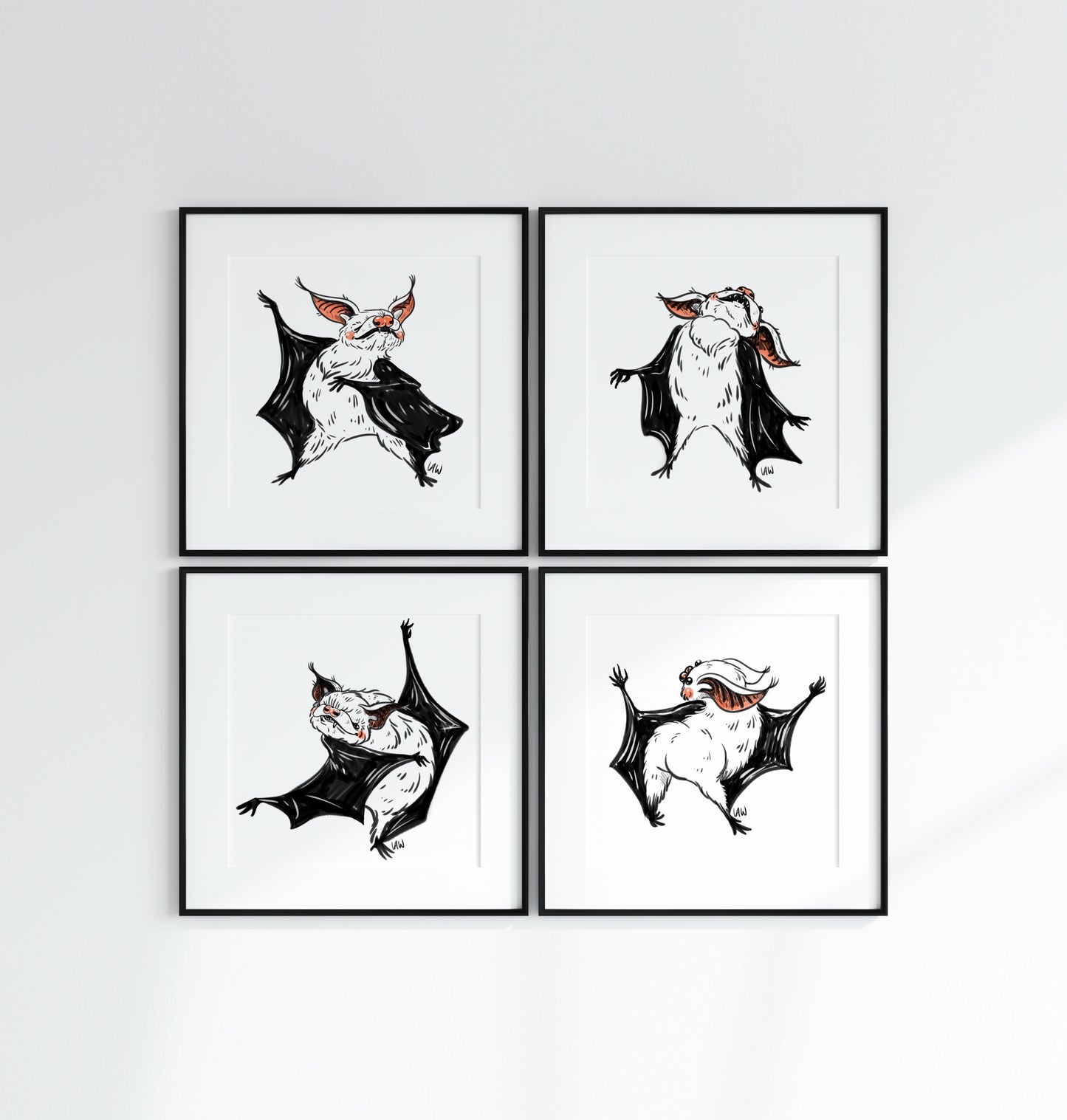Four framed illustrations of bats on a white wall