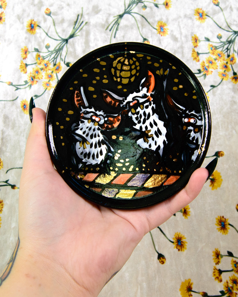 Round ceramic coaster with dancing cartoon bats and a gold disco ball design