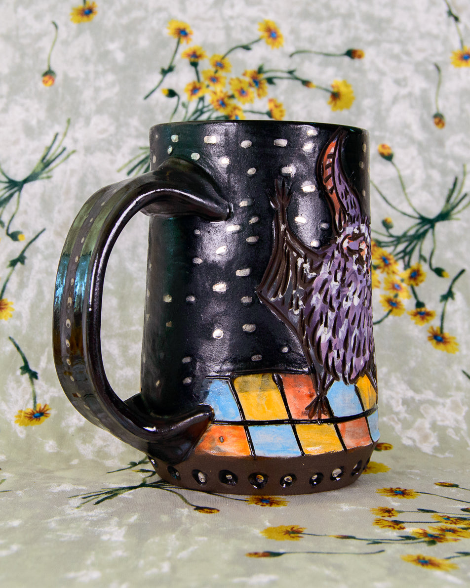 Ceramic mug with artistic design on a floral-patterned background