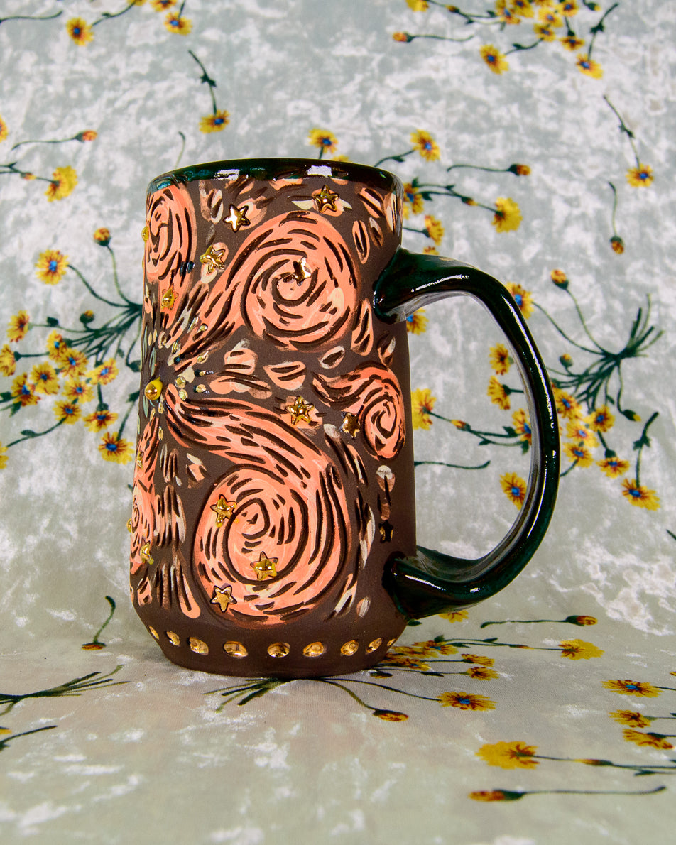 Black stoneware mug with cartoon magic swirl illustrations and gold luster stars