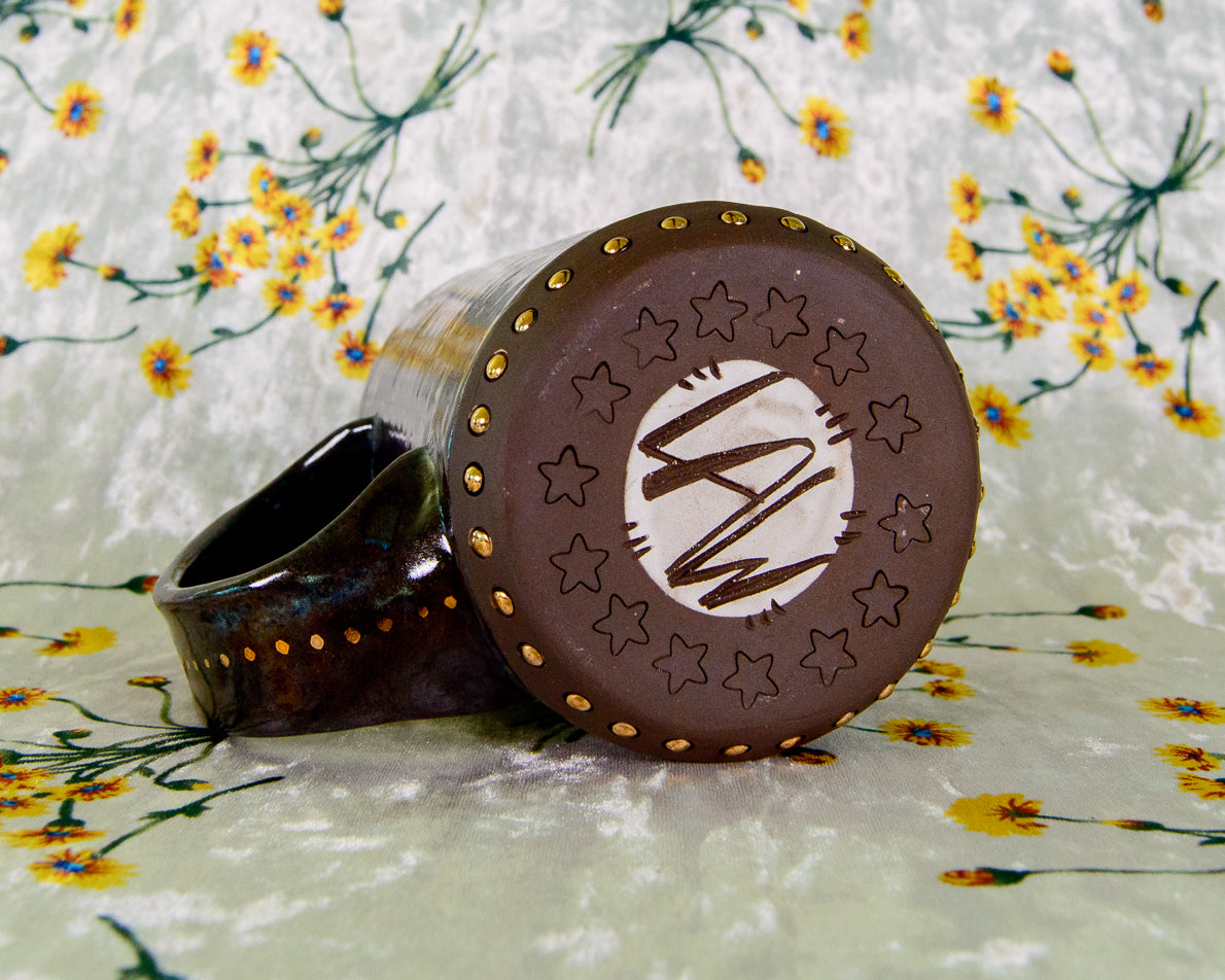 Bottom of a ceramic mug with LAW Leigh Weinberg signature, maker's mark from Lawful Studios