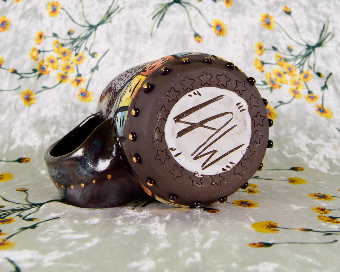Bottom of a handmade ceramic mug with Leigh Weinberg's signature ceramics maker's mark, LAW