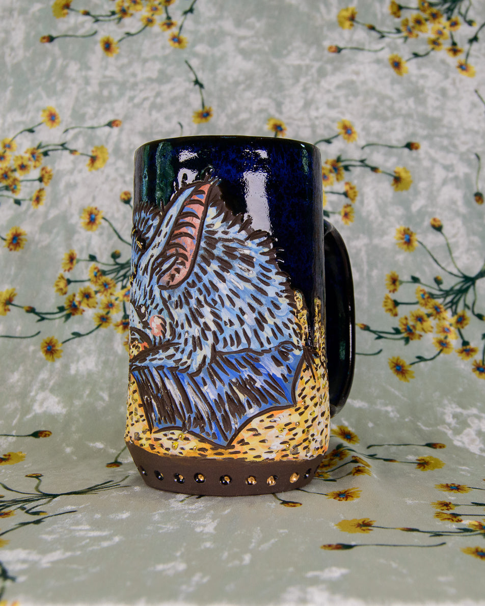 Mug with a blue bat design on a floral background