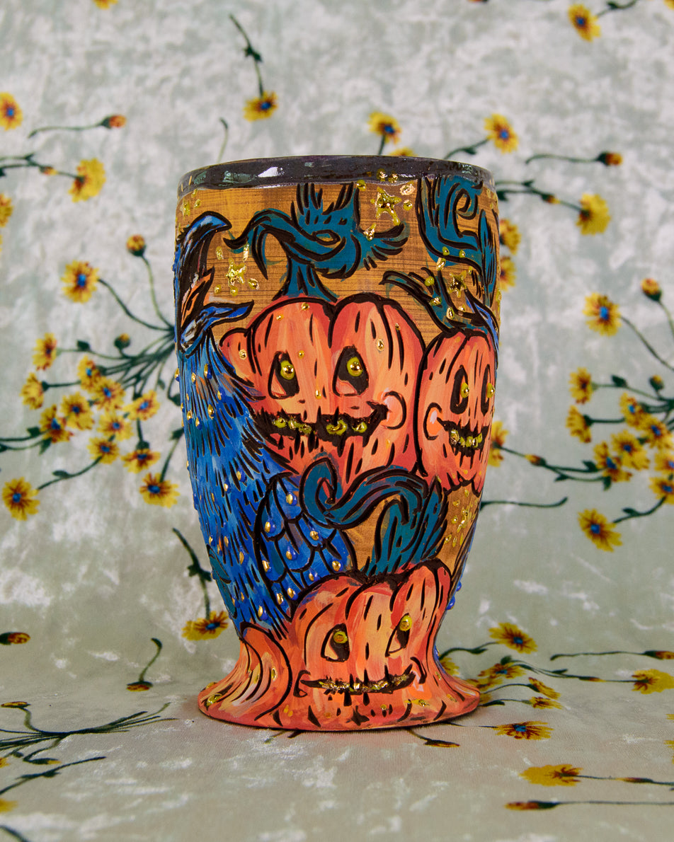 Ceramic cup with a colorful cartoon halloween pumpkin design