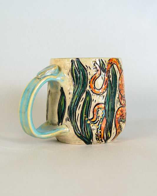 Ceramic mug with a colorful octopus design on a light gray background