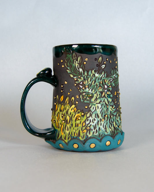 Ceramic mug with artistic deer design on a white background