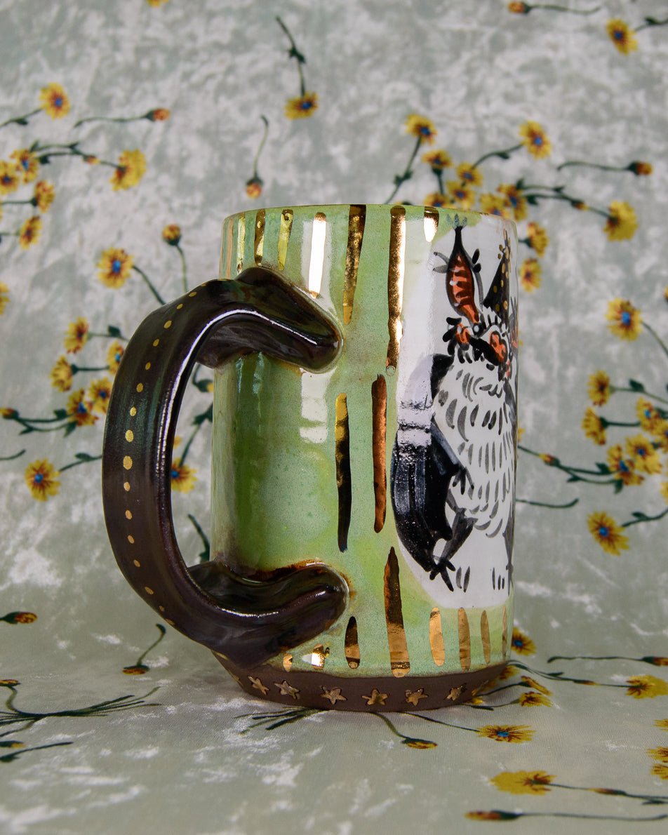 Handmade colorful green and black mug with gold details on the handle