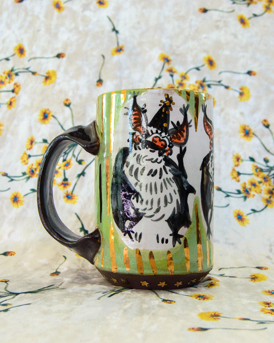 Ceramic mug with a cute cartoon bat design with gold stripes and dots