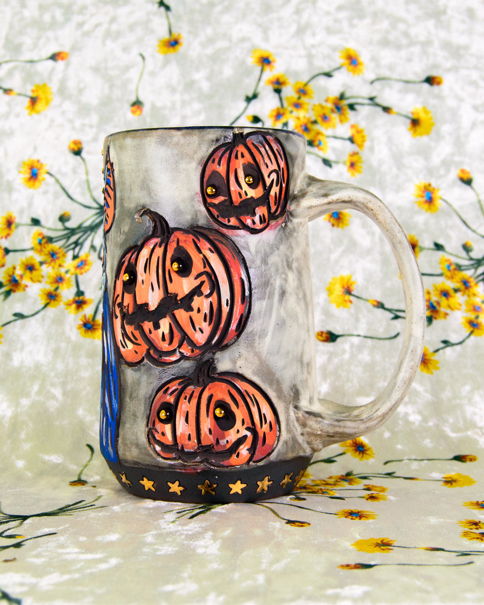 White mug with Halloween-themed pumpkin jack o lantern design on a floral background