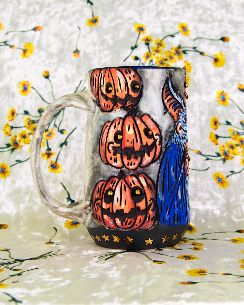 Mug with halloween pumpkin design and a white handle on a floral background
