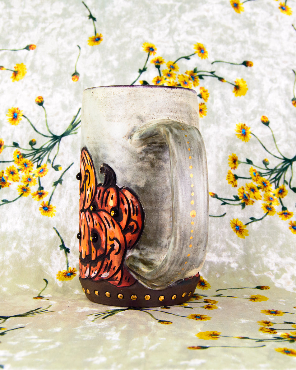 Decorative ceramic mug with pumpkins on a white and gold background