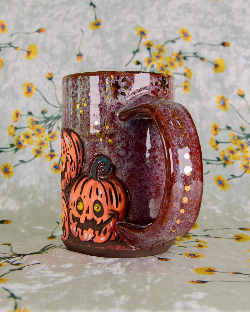 Ceramic mug with Halloween design of pumpkins on a floral background