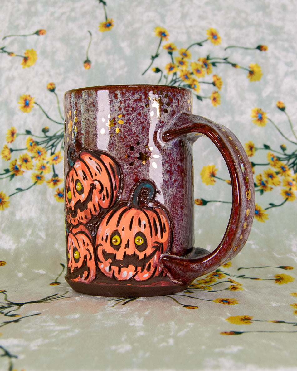 Ceramic mug with pumpkin design on a floral background