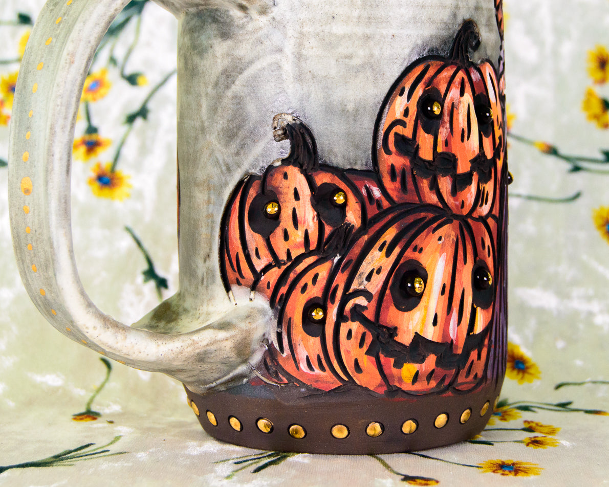 Ceramic mug with hand-painted halloween pumpkins on a floral background