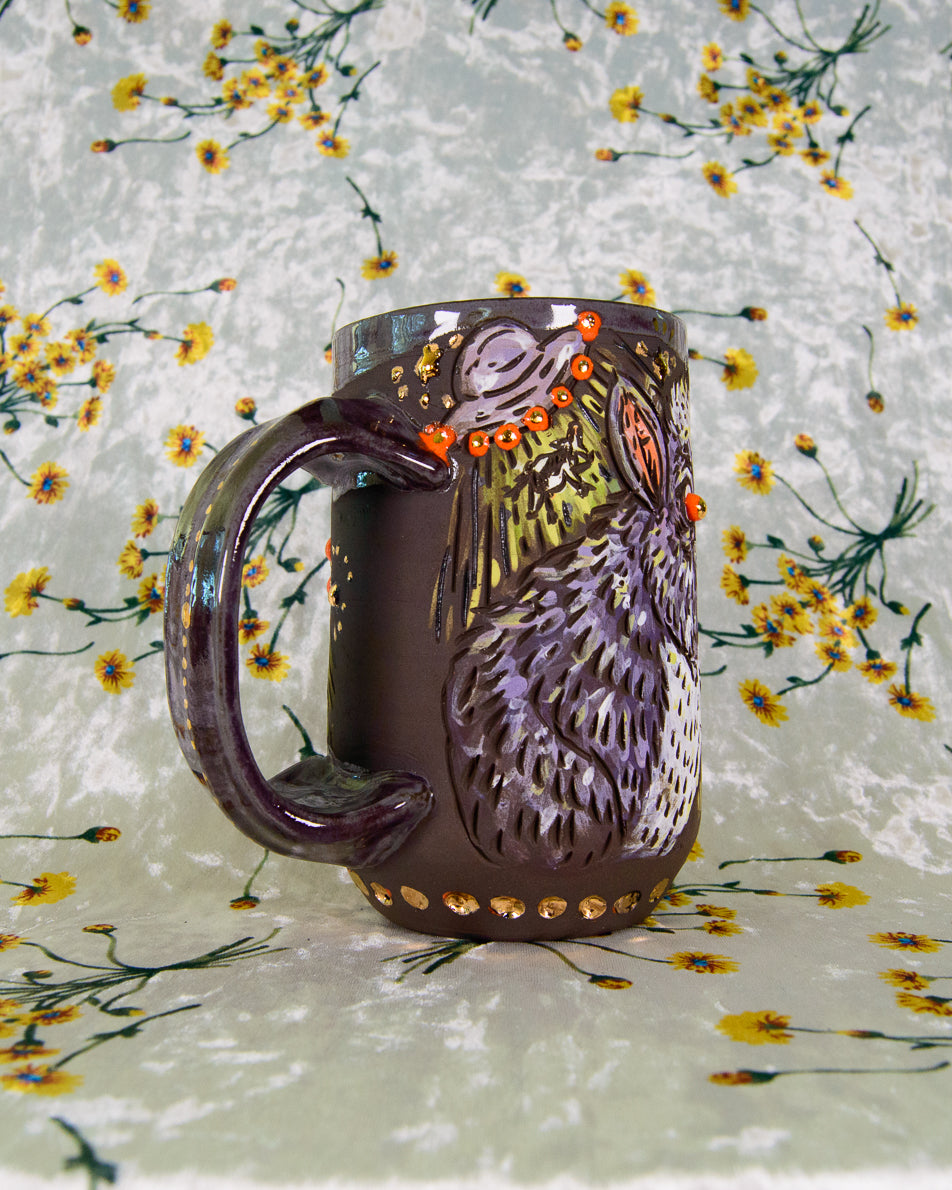 Stoneware mug with purple alien ship designs and floating. cows