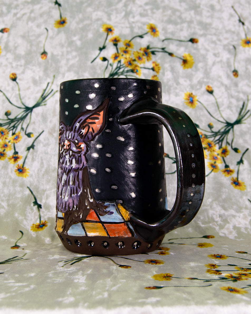 Decorative mug with bat design on a floral background