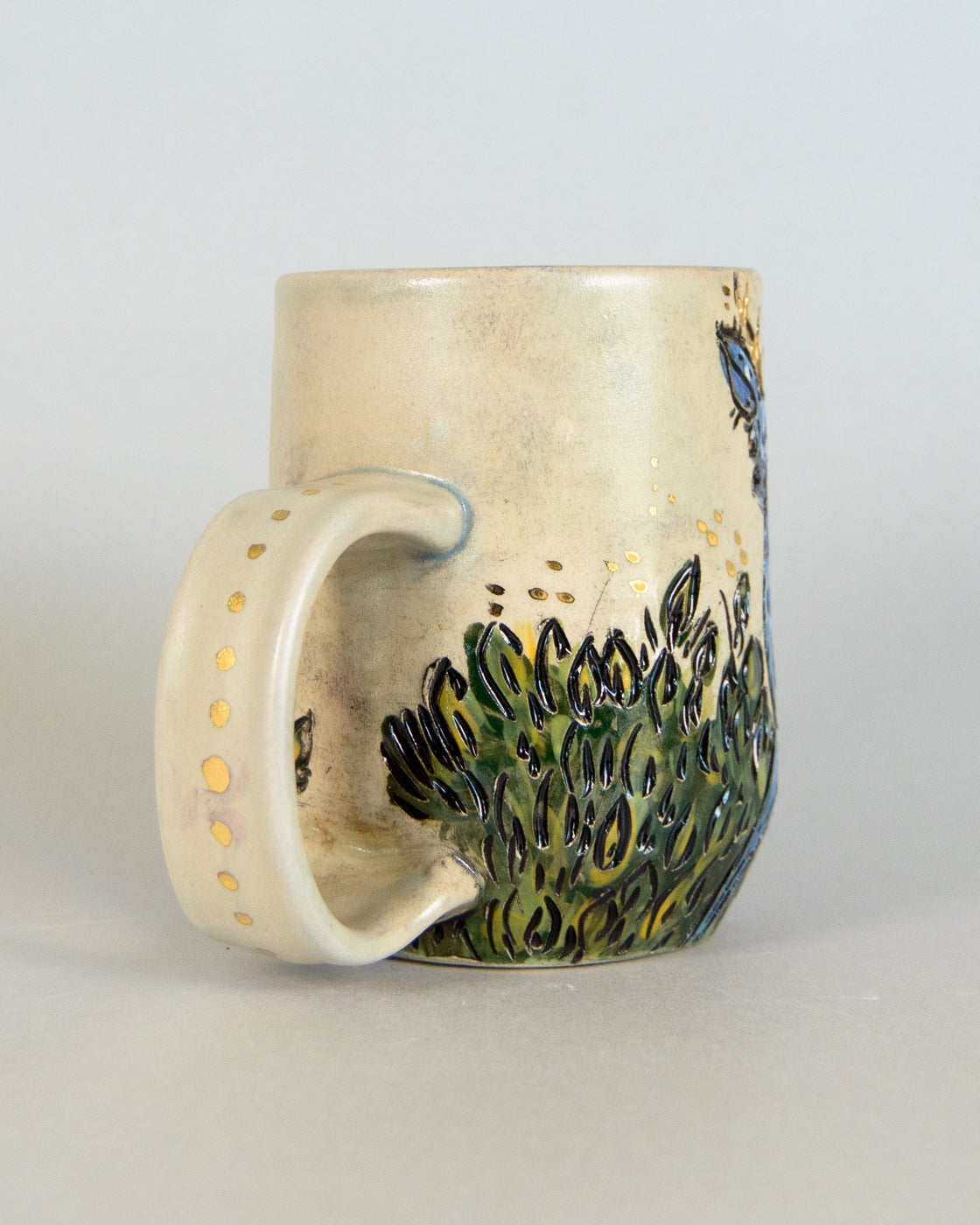 Ceramic mug with a nature-themed design on a light gray background