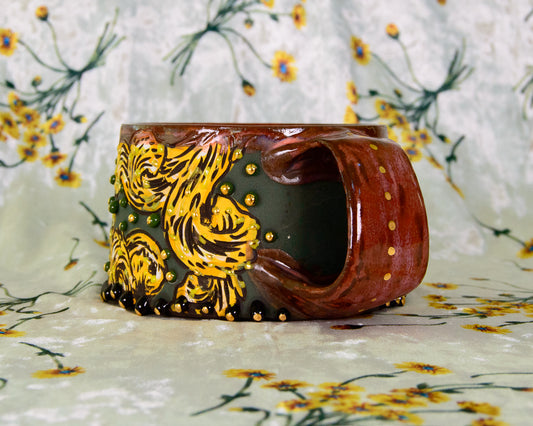 Ceramic mug with yellow leaf design on a floral background
