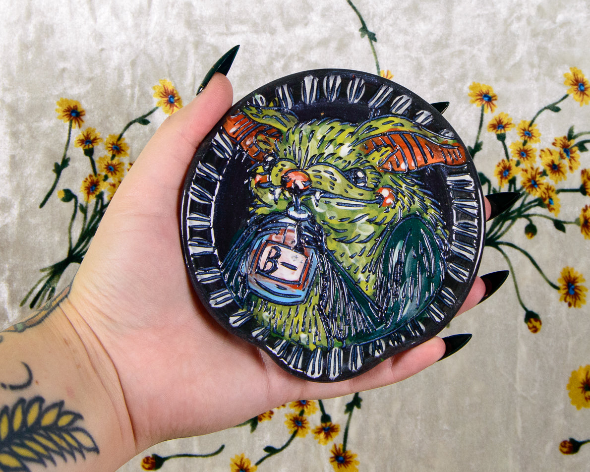 Black ceramic spoon rest with a cute cartoon bat design