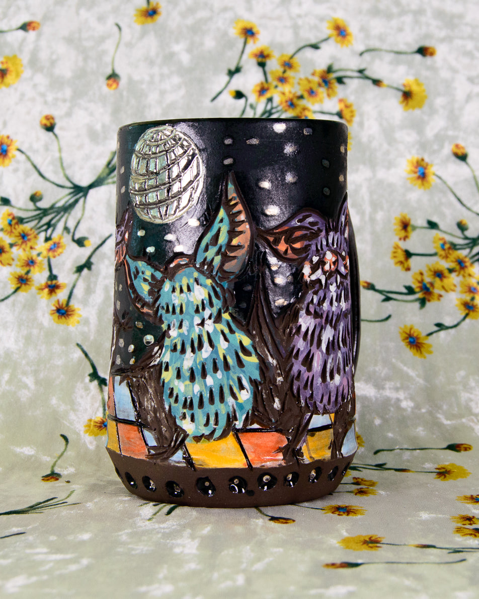 Illustrated ceramic mug with dancing bats design and a silver disco ball
