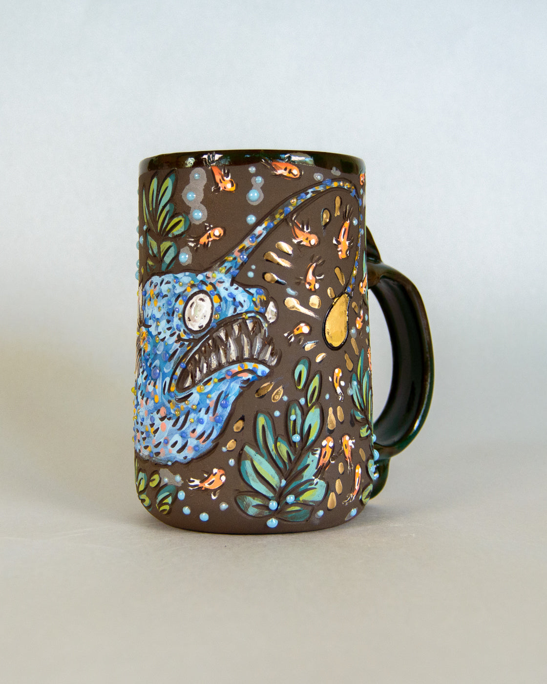 Ceramic mug with a blue fish design on a white background