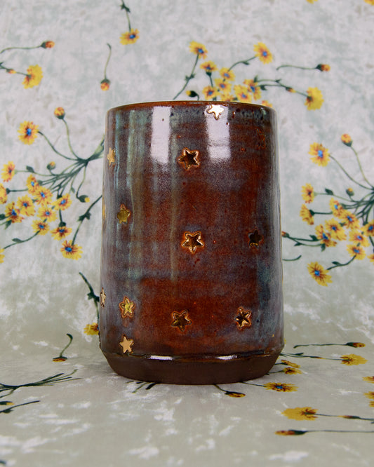 Ceramic cup with star patterns on a floral background