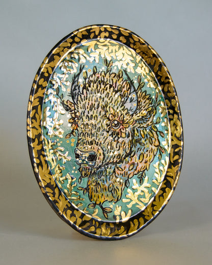 Decorative plate with a bison design on a gray background