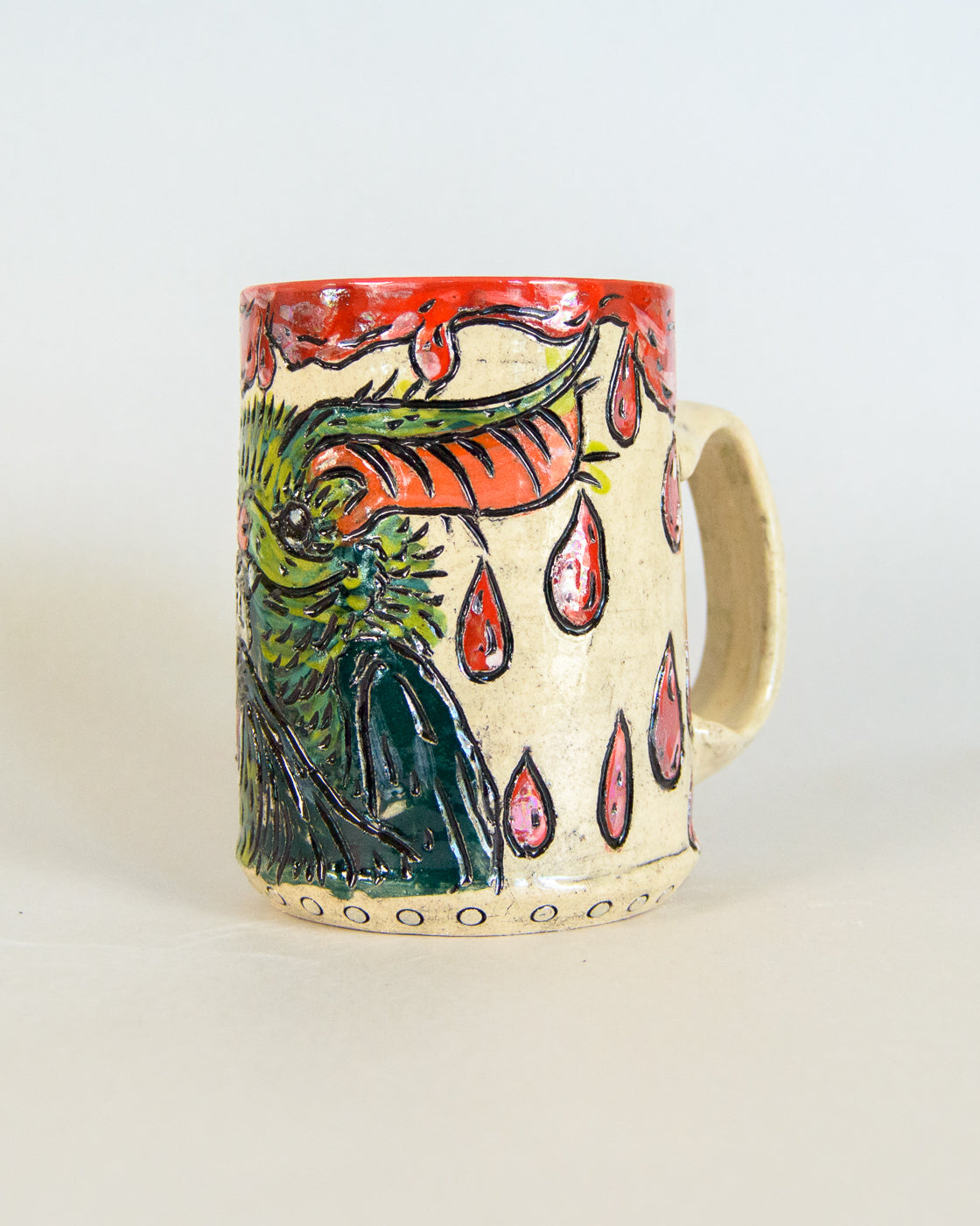 Ceramic mug with a colorful bat design on a white background