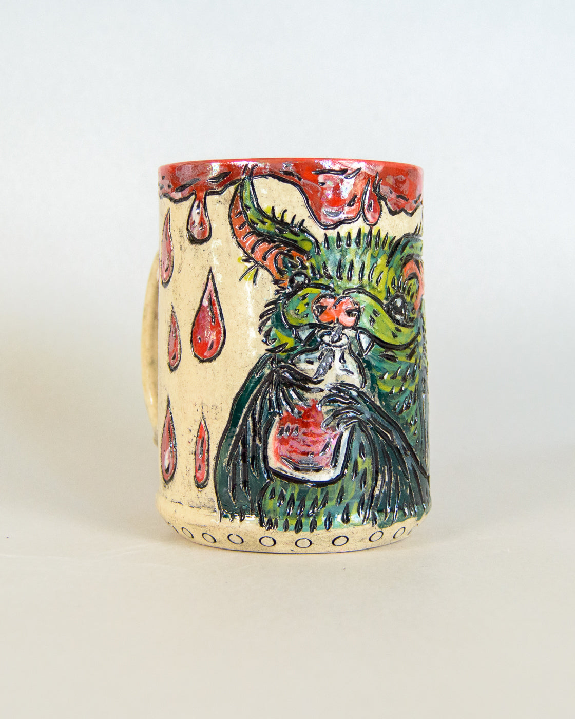 Ceramic mug with artistic bat design on a white background