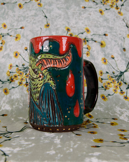 Colorful ceramic mug with a bat and blood drip design on a floral background
