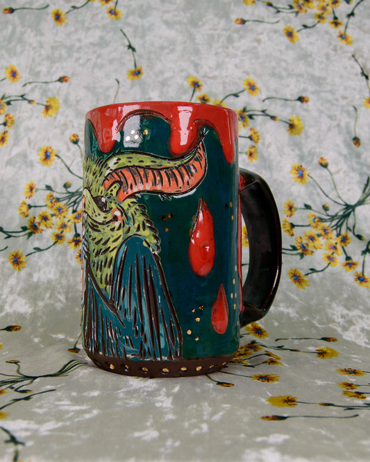 Colorful ceramic mug with a bat and blood drip design on a floral background