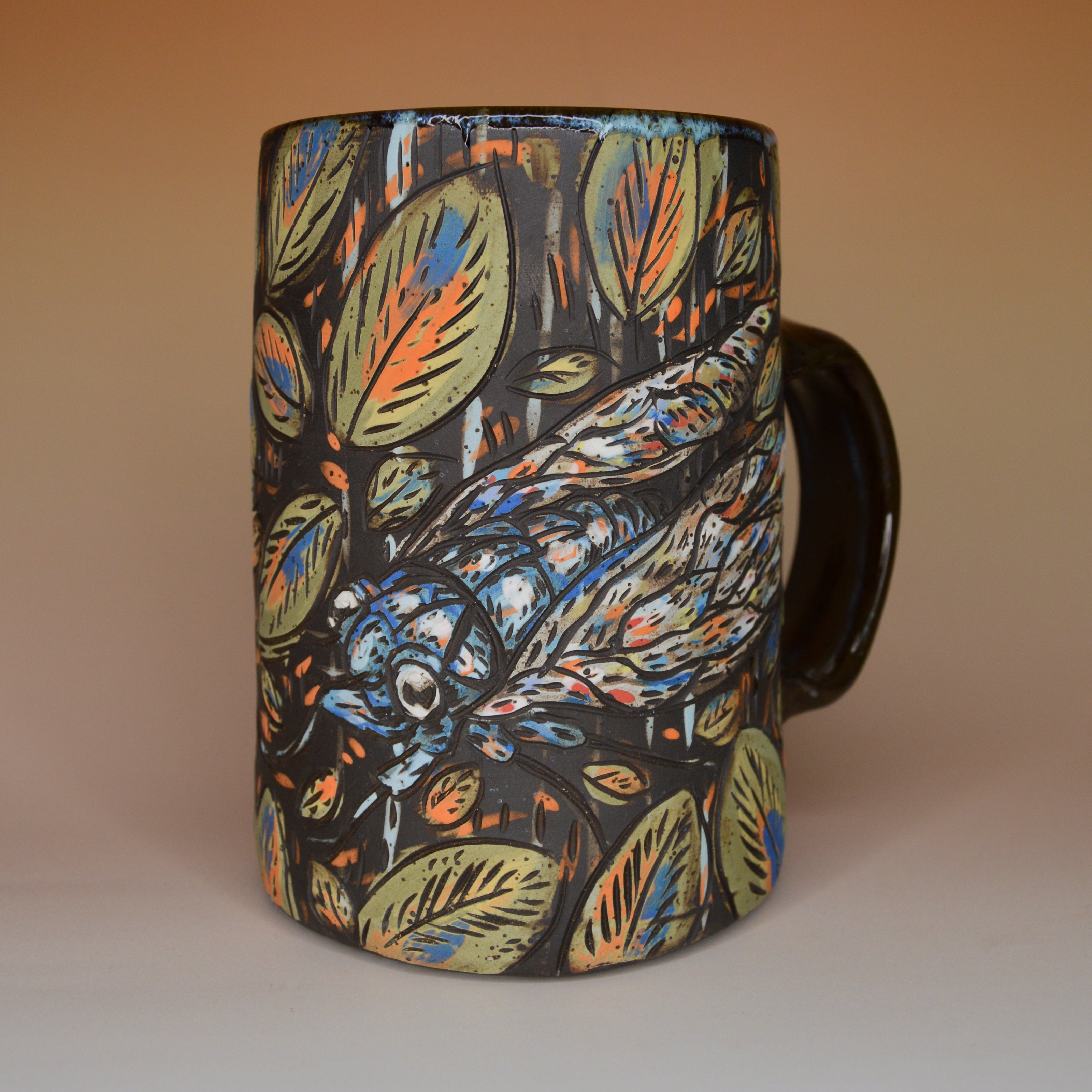 Handmade ceramic stoneware mug with rustic blue cicadas and leaf designs