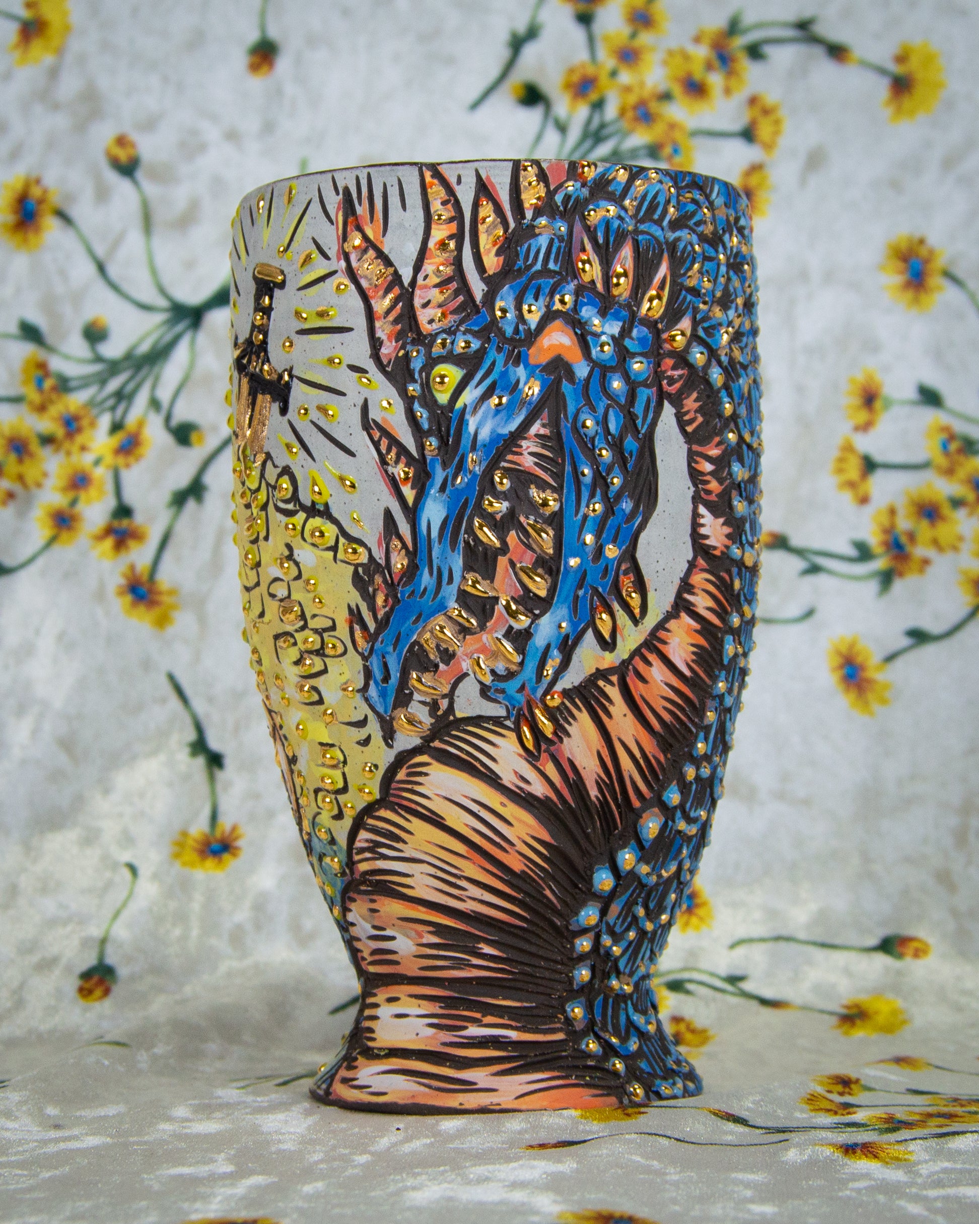 Handmade ceramic goblet decorated with a colorful stylized blue dragon design