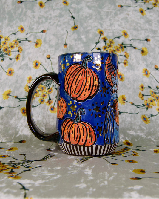 Blue glazed ceramic mug with cute halloween pumpkin designs