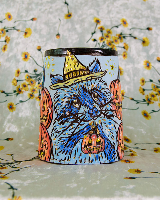 colorful blue and orange mug with a halloween raccoon design