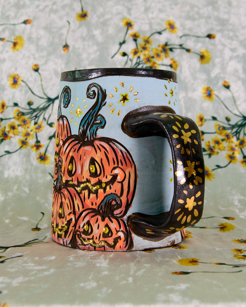 Decorative mug with a pumpkin design on a floral background
