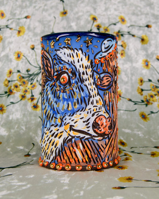 Colorful Ceramic mug with a cartoon cow design and gold star details