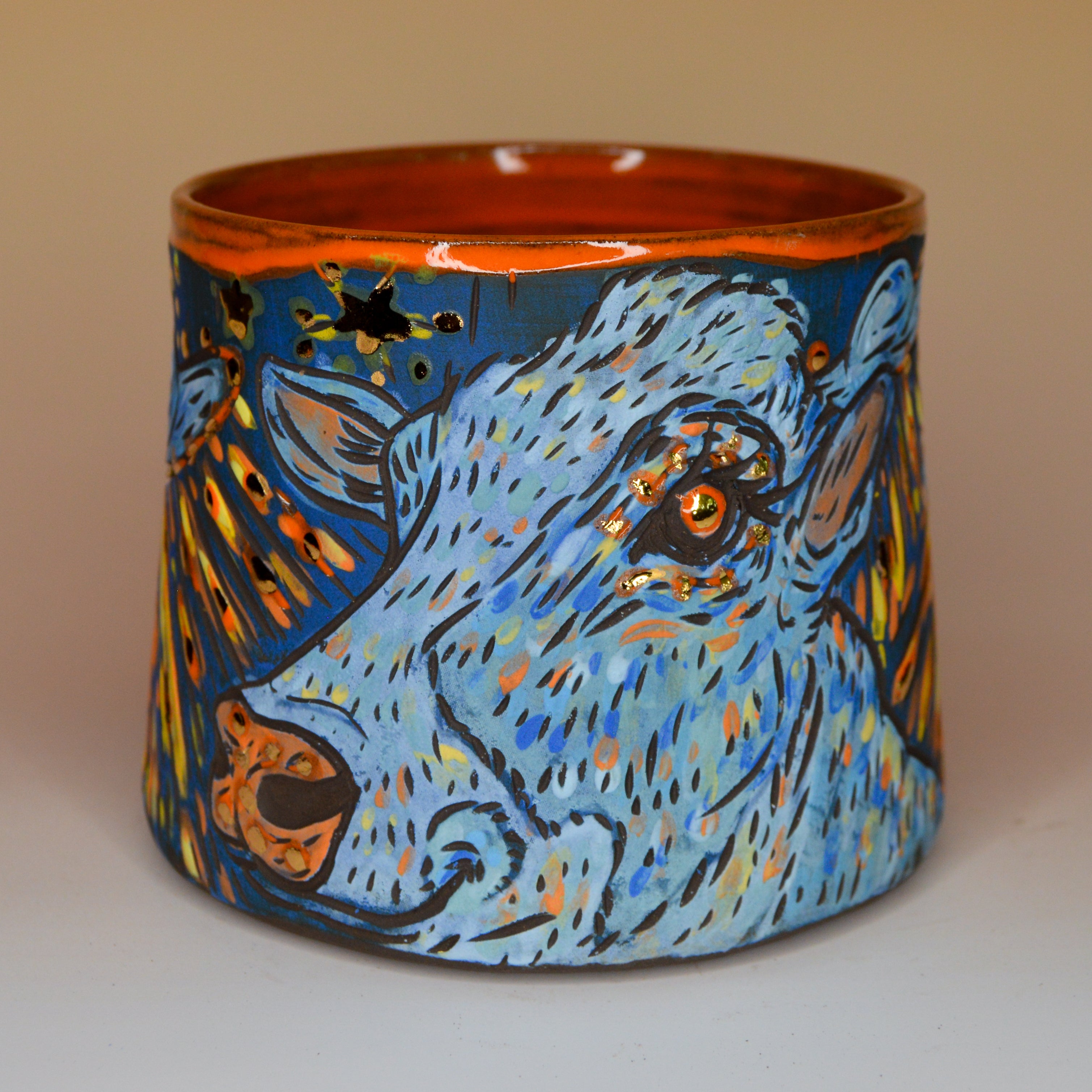 Handmade ceramic stoneware mug with an orange and blue cow design with stars and alien ufos