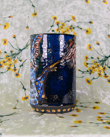 Blue and black ceramic mug with gold and rainbow luster details