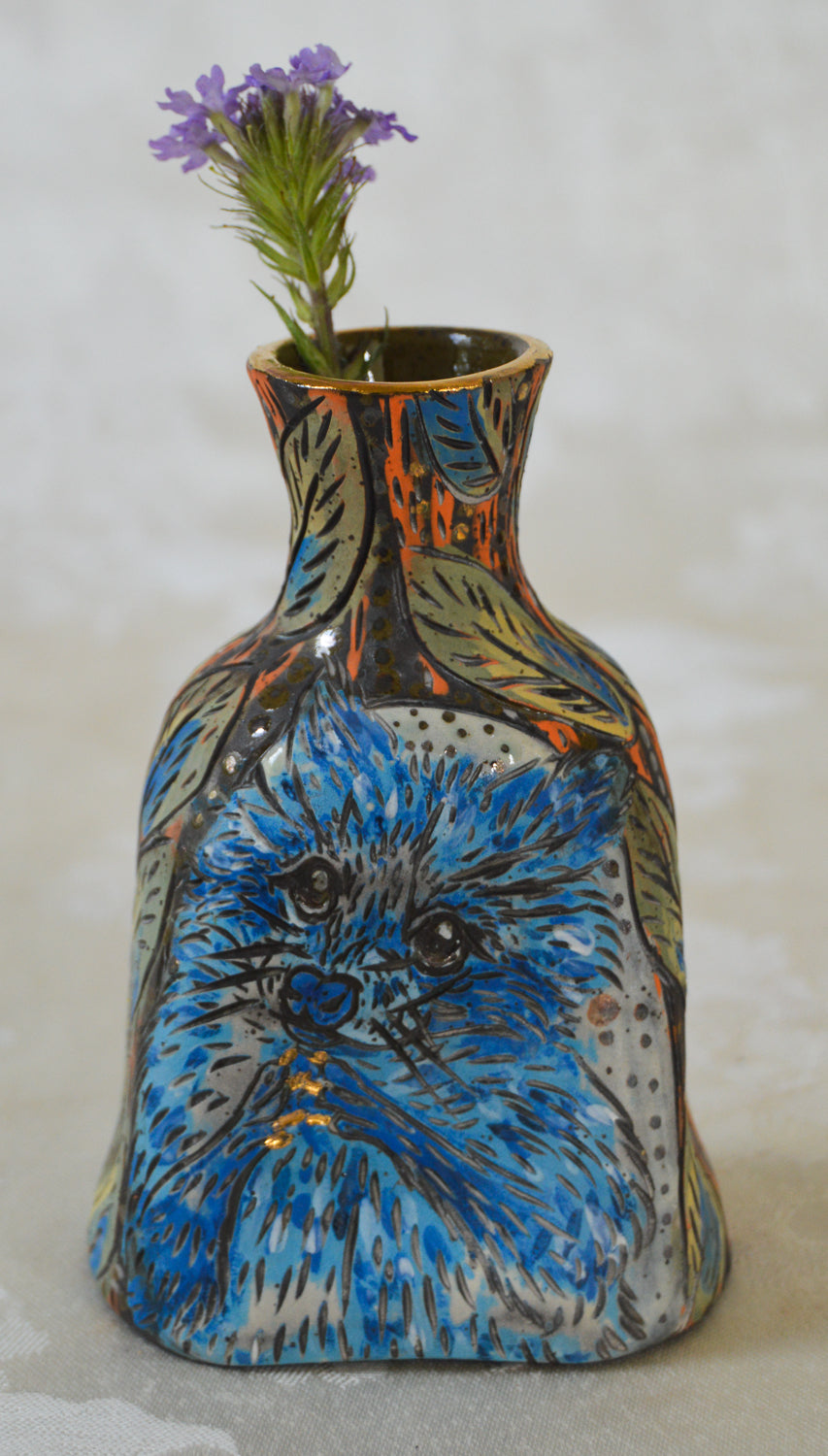 Handmade ceramic stoneware vase with a blue raccoon design