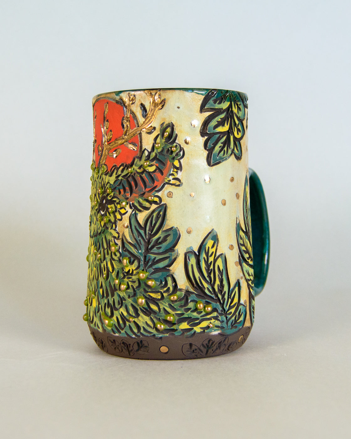 Ceramic mug with nature-themed design on a light gray background